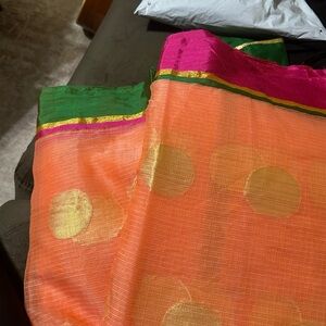 Peach color border saree with a green blouse